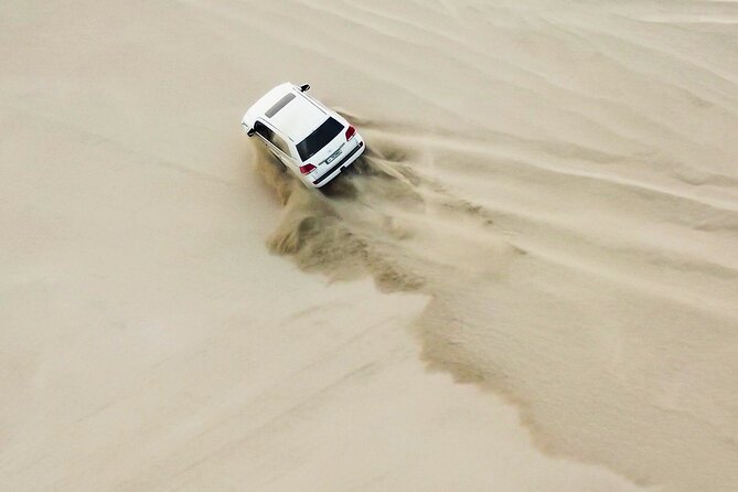 Doha-Private half day safari Sunrise/Sunset - Dune Bashing, Sand Boarding, and Camel Rides