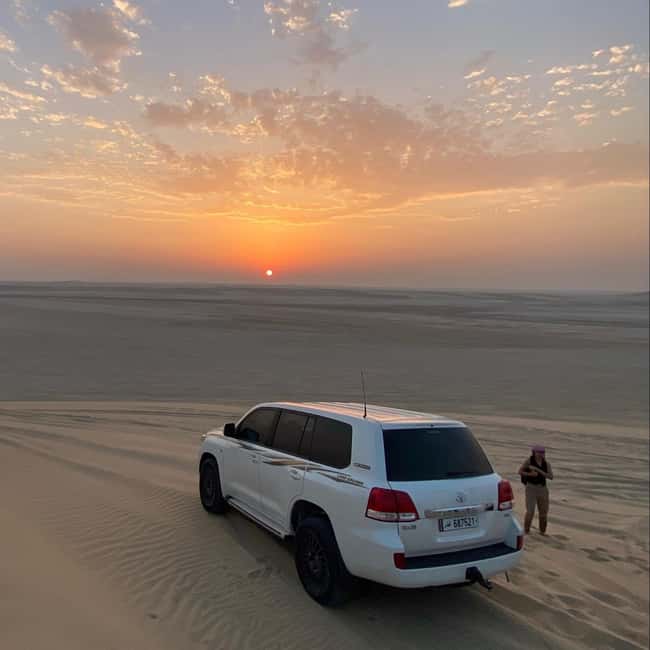 Doha Qatar : sealine adventure Camel Ride sandboard Sunset - The sandboarding stop: where the dunes turn into a slide