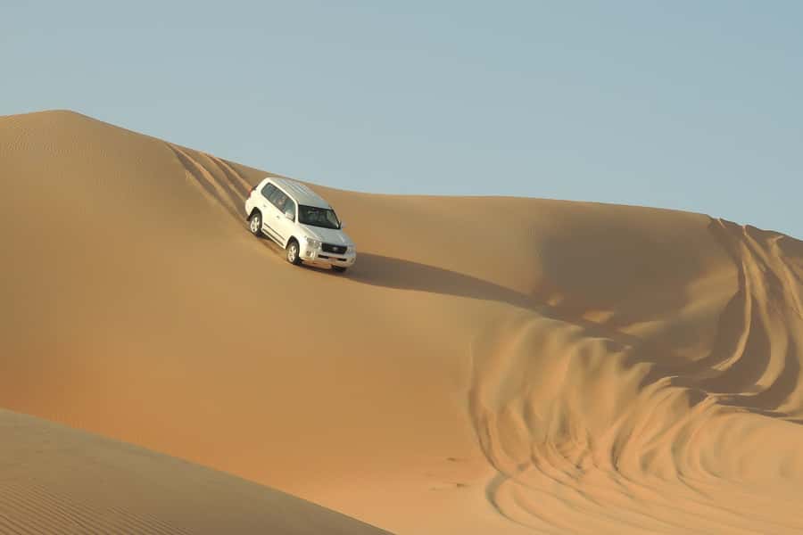 Doha Safari: ATV Ride, Dune Bashing, & Sandboarding Fun - The local camp pause: tea, camel time, and real desert pacing